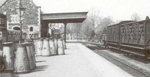 milk churns at Malmesbury station, c 1920s